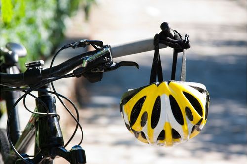 Handle bars of a bicycle with a helmot hanging off them